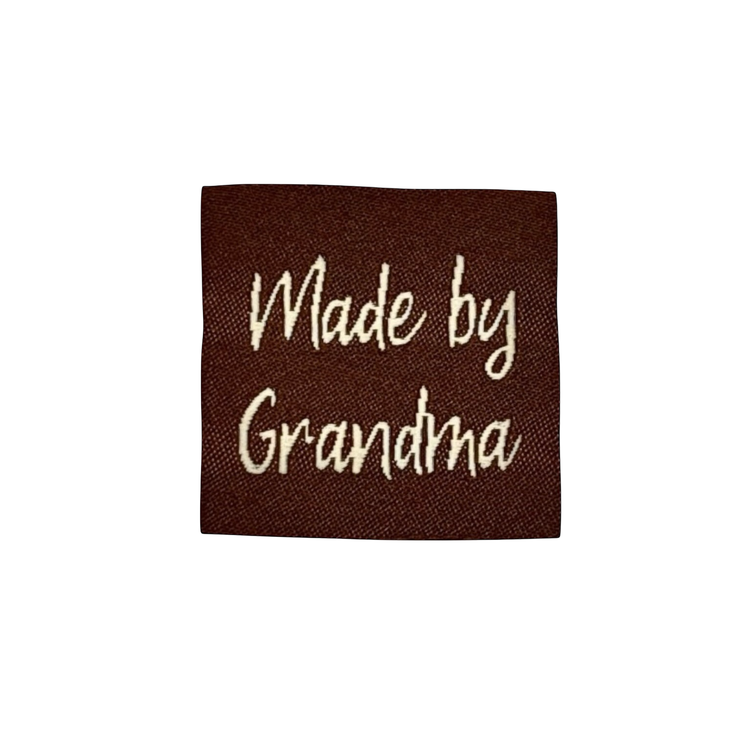 Bruin stoffen label met crèmekleurig geborduurd opschrift Made by Grandma