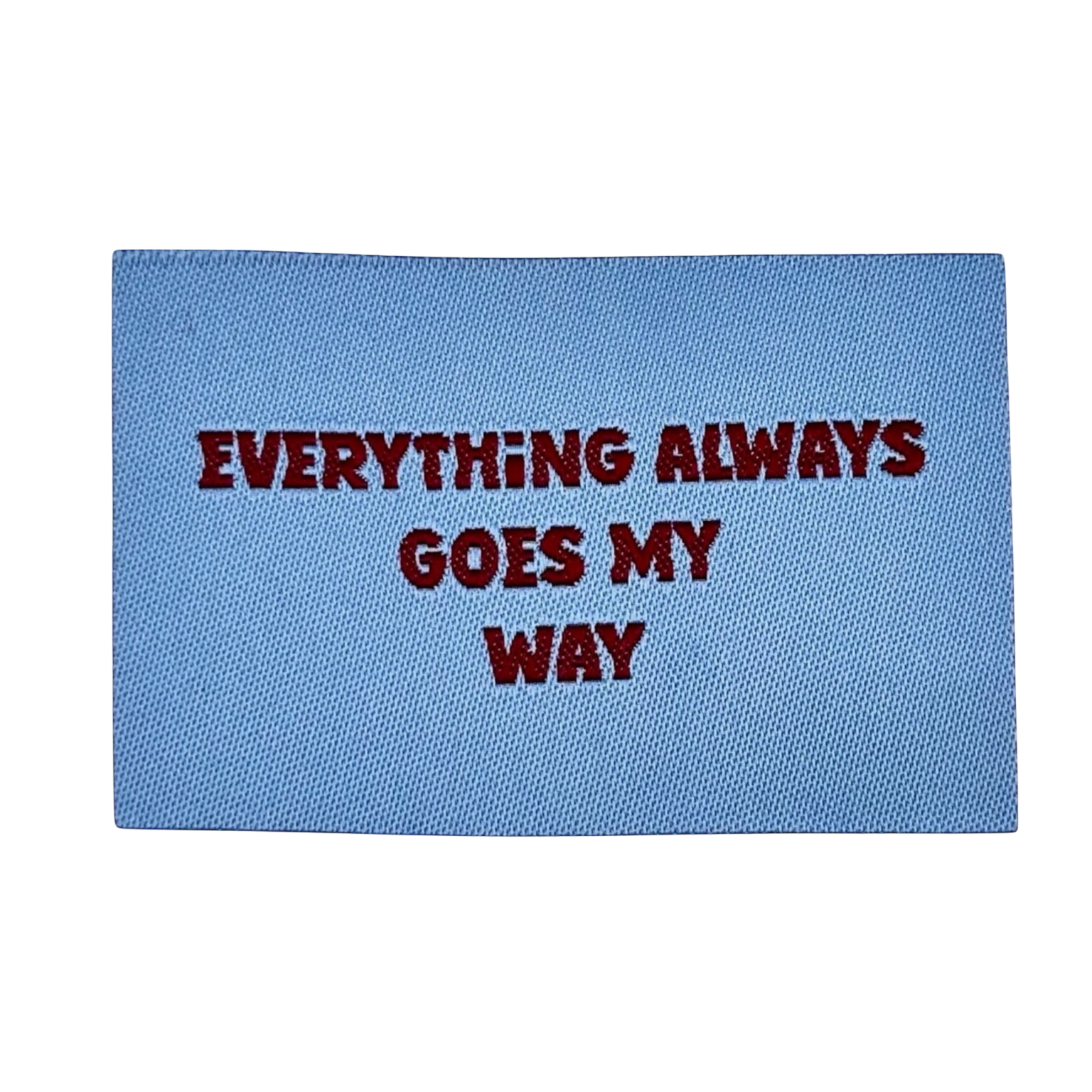 Blauwe deurmat met bordeauxrode tekst Everything Always Goes My Way in hoofdletters