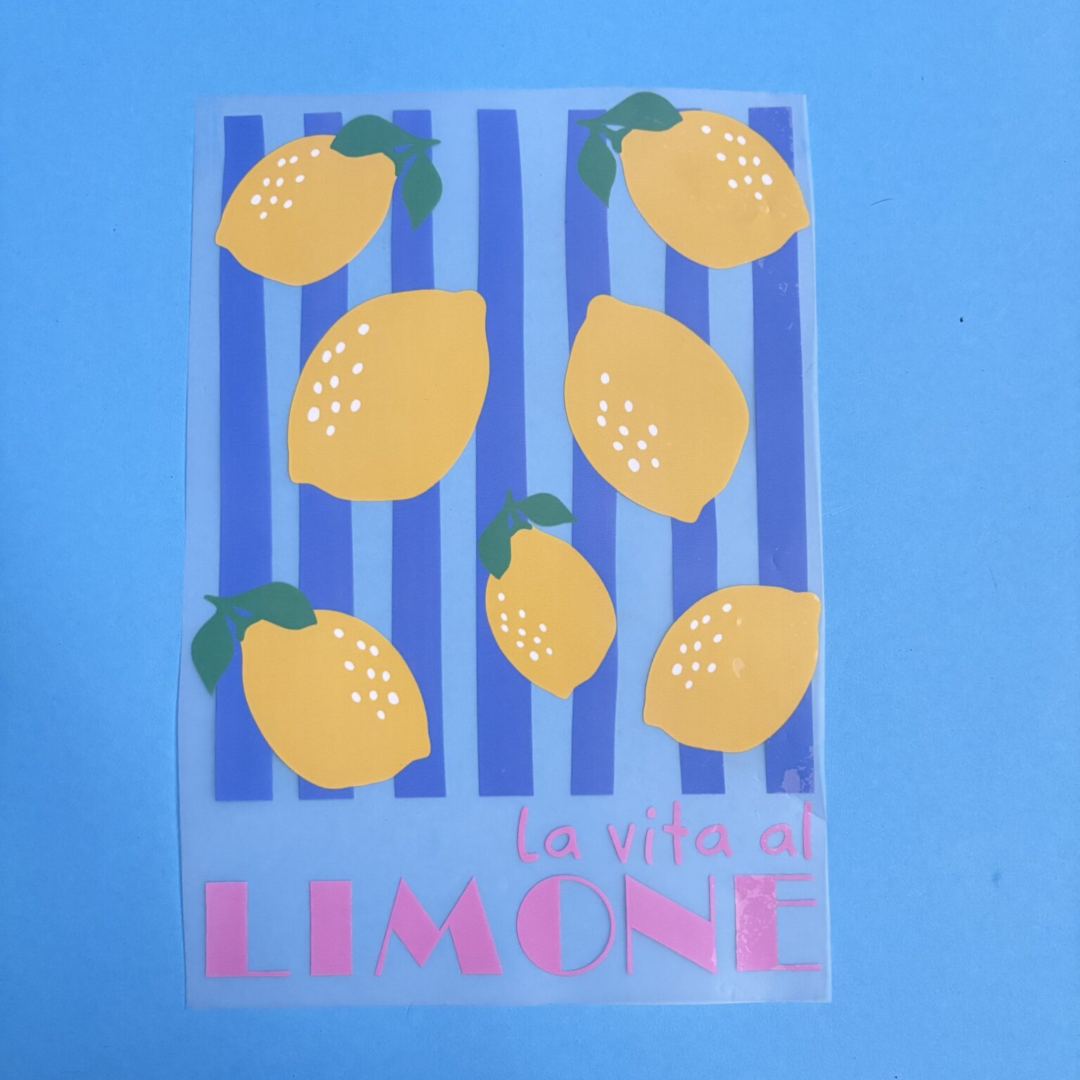Decoratief keukenposter met citroenen op blauwe strepen en roze tekst 'La vita al Limone